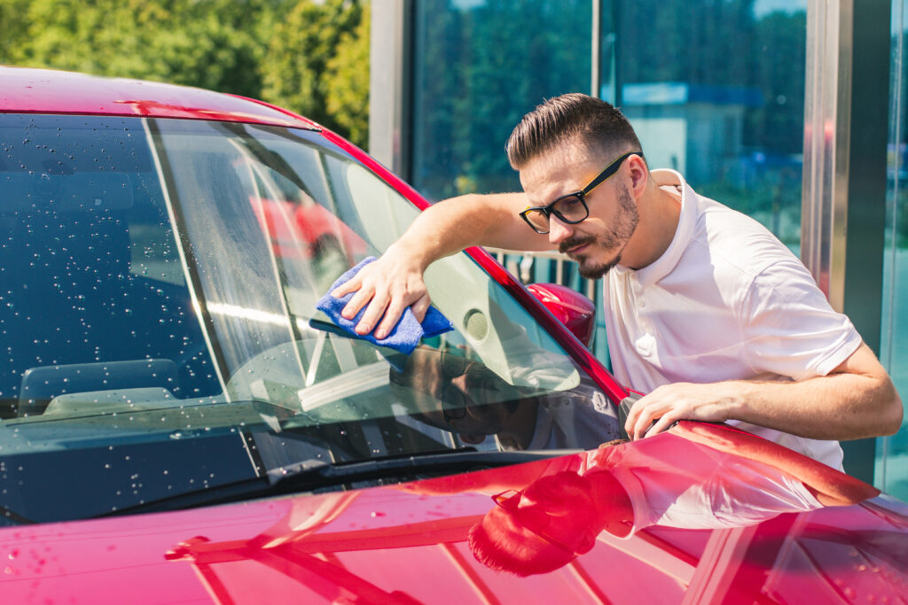 a man cleaning car after repair the glass crack